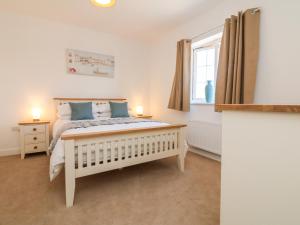 a bedroom with a bed and a window at 1 Marsh Gardens in Dunster