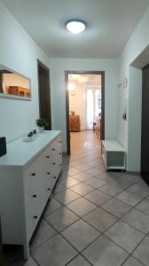 a kitchen with a white counter and a tile floor at La Casa di Grazia in Ronciglione