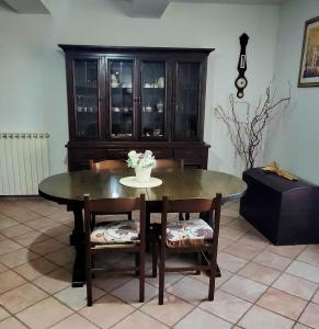 a dining room with a table and chairs and a cabinet at La Casa di Grazia in Ronciglione +30 photos