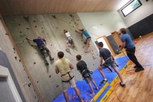 a group of people on a climbing wall at Familienhotel Post in Millstatt