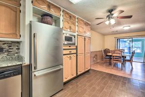 a kitchen with a stainless steel refrigerator and a table at Lakefront Macon Getaway Grill, Pet Friendly! in Macon