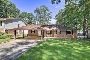 a home with a large yard with a driveway at Lakefront Macon Getaway Grill, Pet Friendly! in Macon