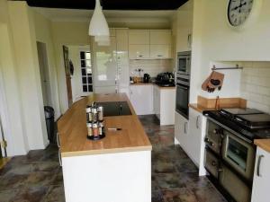 a kitchen with a wooden counter top in a room at Country Home with Gardens in Newtown