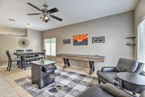 a living room with a ping pong table at Goodyear Desert Oasis with Patio and Game Room! in Goodyear