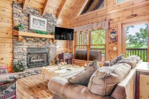 a living room with a couch and a fireplace at Almost Heaven in Pigeon Forge