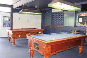 two pool tables are in a room with at Tin Can Bay Budget Accommodation in Tin Can Bay