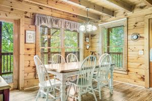 a dining room with a table and chairs at Almost Heaven in Pigeon Forge