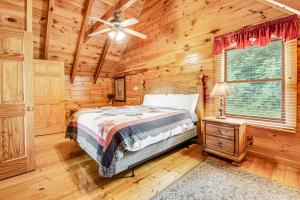 a bedroom with a bed and a ceiling fan at Almost Heaven in Pigeon Forge +32 photos