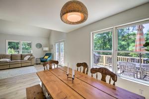 a living room with a wooden table and chairs at Modern Eckerty Home with Deck on Patoka Lake! in Taswell