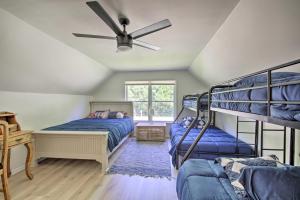 a bedroom with two bunk beds and a ceiling fan at Modern Eckerty Home with Deck on Patoka Lake! in Taswell