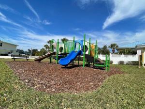a playground with a slide in a park at Modern Townhouse with Pool Close to Disney & Silver Spurs Arena in Kissimmee