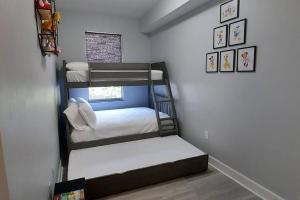 a room with three bunk beds in it at Modern Townhouse with Pool Close to Disney & Silver Spurs Arena in Kissimmee +55 photos