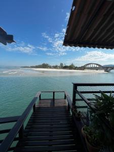 a stairway leading into the water with a bridge in the background at Casa Marambaia 2 in Rio de Janeiro