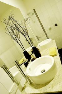 a bathroom with a white sink and a toilet at Abode Bendigo Apartments in Bendigo