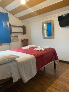 Postel nebo postele na pokoji v ubytování Suítes Casa da Colônia