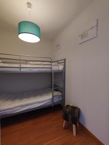 a room with two bunk beds and a light at Le Cosy Pyrénées pied de pistes Sérias in Germ