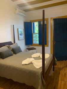 Postel nebo postele na pokoji v ubytování Suítes Casa da Colônia