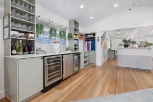 a large kitchen with wooden floors and white walls at Surfland Hotel in Lincoln City