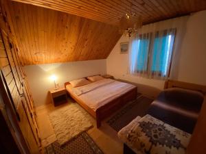 a small bedroom with a bed and a window at Apartmani Laušević in Žabljak