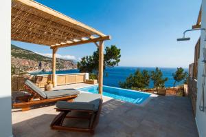 a villa with a swimming pool and a pergola at Akropolis Village Complex of Luxury Residence in Karpathos