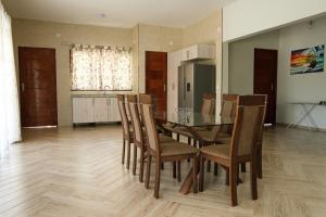 a kitchen and dining room with a table and chairs at Bilene Brown House in Vila Praia Do Bilene