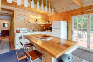 a kitchen with a refrigerator and a table in a cabin at Loon Cove in Waterville