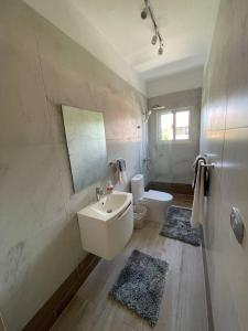 a bathroom with a sink and a toilet and a mirror at Boca Paraiso in Boca Chica