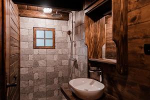 a bathroom with a toilet and a window at Black River in Kolašin