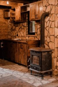 a stove in a room with a stone wall at Black River in Kolašin