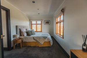 a bedroom with a bed and a window at Misty Cove Homestead in Renwick