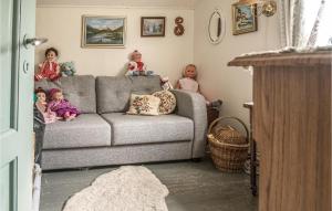 a group of children sitting on a couch in a living room at Amazing Home In Ytterøy With Wifi in Ytteroy