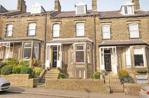 a large brick house with a staircase in front of it at Brylie House, Large Central family home in Skipton