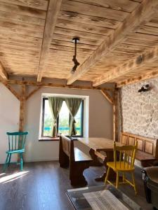a dining room with a large wooden table and chairs at Old Lato's House in Danilovgrad