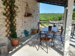 a table and chairs on the balcony of a house at Old Lato's House in Danilovgrad +16 photos