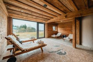 a living room with a couch and a large window at Golfhotel Sonne in Siusi