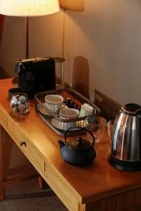 a table with a tray of dishes and a tea kettle at Los Cerros del Chaltén Boutique Hotel in El Chalten