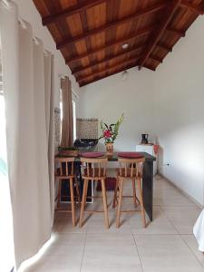 a kitchen with a table and chairs in a room at Chalés Vale dos Pássaros in Paraty