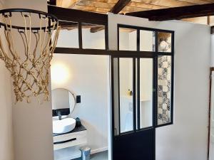 ein Bad mit einem an der Decke hängenden Basketballkorb in der Unterkunft Les Suites de la Tour d'Embas in Vitré
