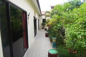 a walkway with potted plants next to a building at Phuket Airport Overnight Hotel in Nai Yang Beach