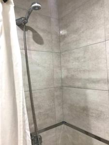 a shower with a shower curtain in a bathroom at Solo Se Trata De Vivir in Tandil