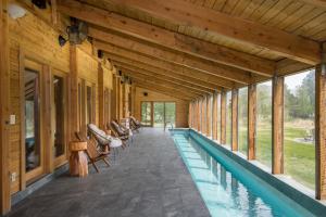 an indoor pool in a house with a wooden ceiling at Bear Lodge with private Pool, Hottub, and Sauna! in Hailey