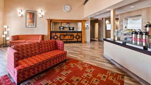 a waiting room with a couch and a pharmacy at Best Western Plus Peoria in Peoria