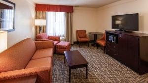 a living room with a couch and a flat screen tv at Best Western Plus Peoria in Peoria +17 photos