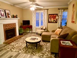 a living room with a couch and a fireplace at Trendy 2Bed 2 Bath Villa In The Village With King Bed in Raleigh