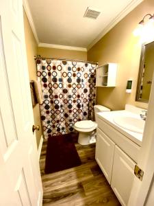 a bathroom with a toilet and a sink at Trendy 2Bed 2 Bath Villa In The Village With King Bed in Raleigh