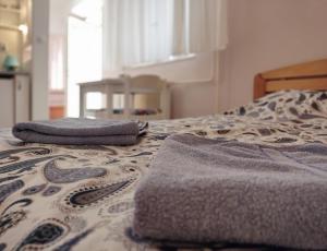 two towels sitting on top of a bed at Ada Belgrade Apartment in Belgrade