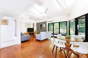 a living room with a table and chairs at Tropical Tranquillity - Spacious Poolside Cottage in Nightcliff