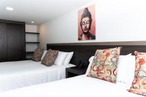 Postel nebo postele na pokoji v ubytování Hotel Qatar Cali
