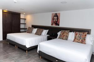 Postel nebo postele na pokoji v ubytování Hotel Qatar Cali