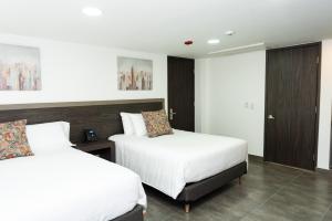 Postel nebo postele na pokoji v ubytování Hotel Qatar Cali